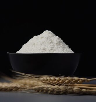 a bowl of flour sitting on top of a table